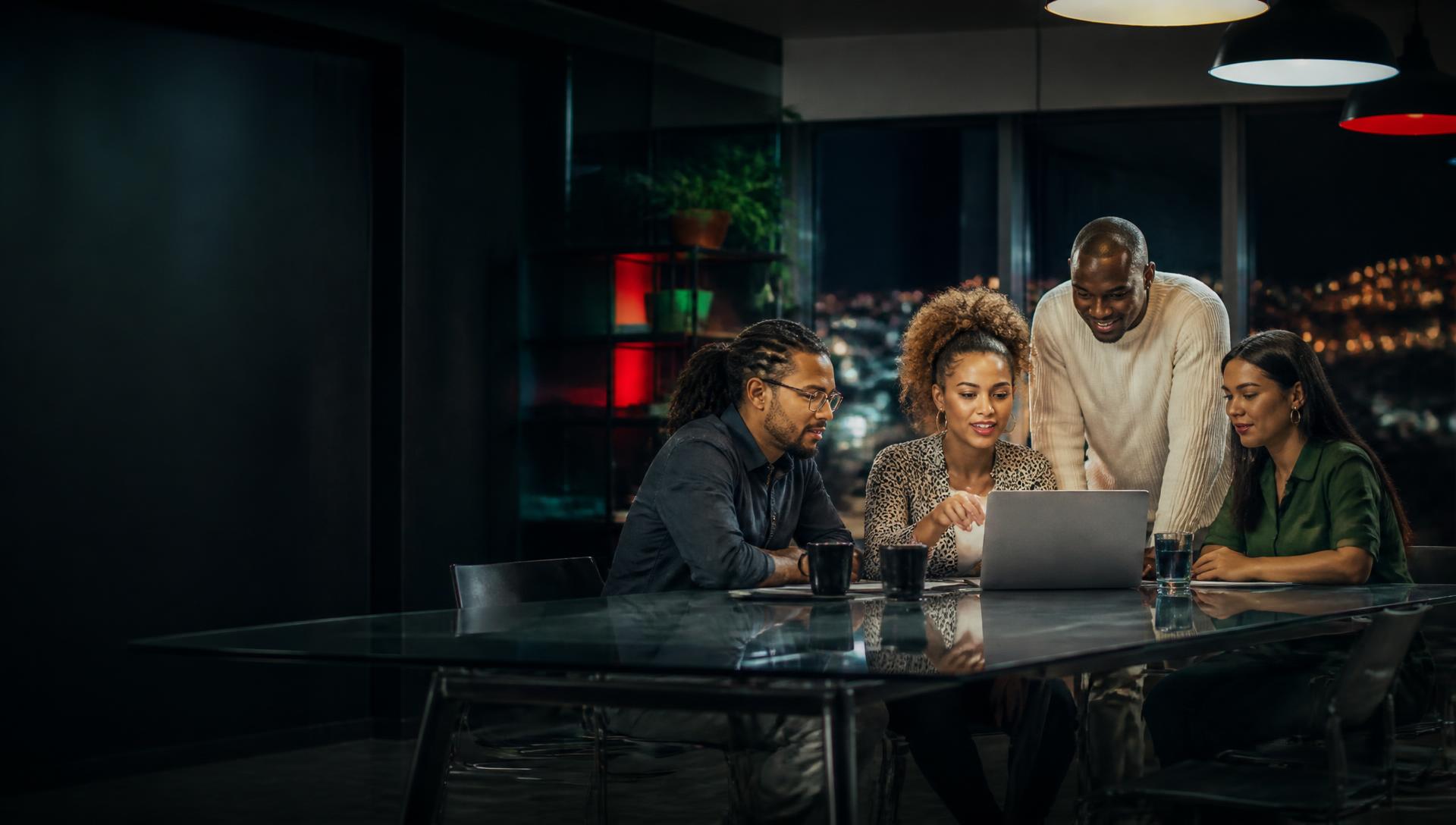 South African digital professionals collaborating around a laptop